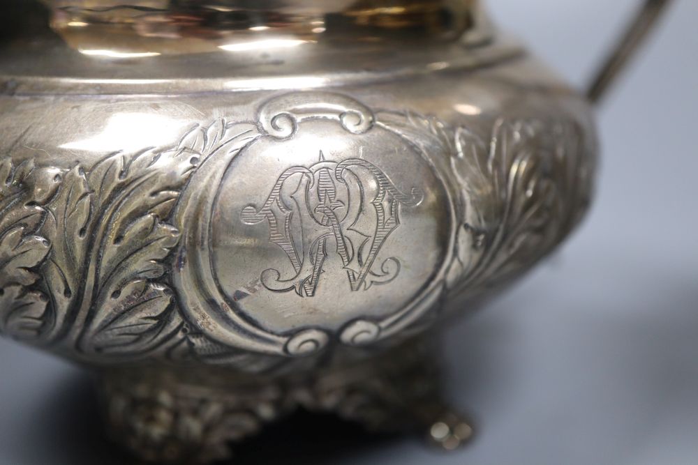 A George IV embossed silver lidded sugar bowl and matching cream jug, Joseph Angell I, London, 1823, 34.5oz.